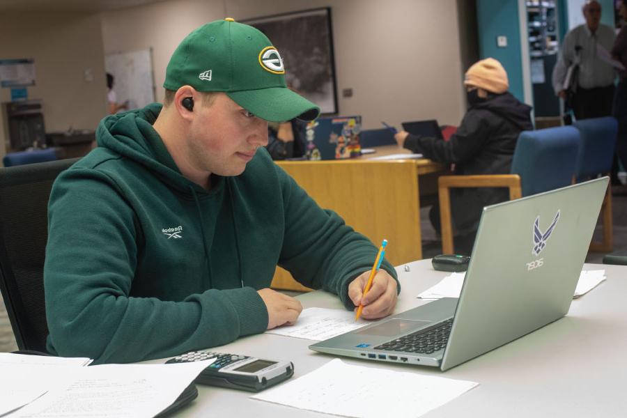 San Juan College Student working on laptop